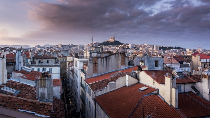 Marseille cityscape with Notre-Dame de la Garde basilica at sunrise
