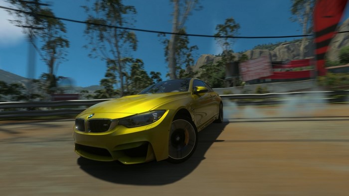 Yellow BMW M4 Coupe drifting on a race track