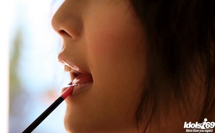 Woman applying lipstick