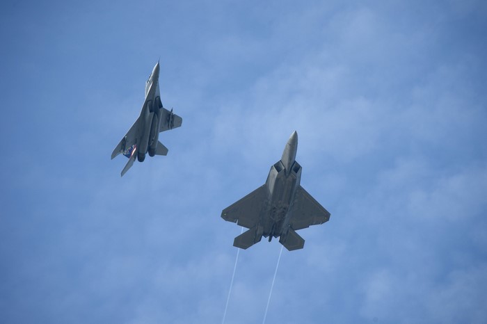 Two fighter jets flying in the sky