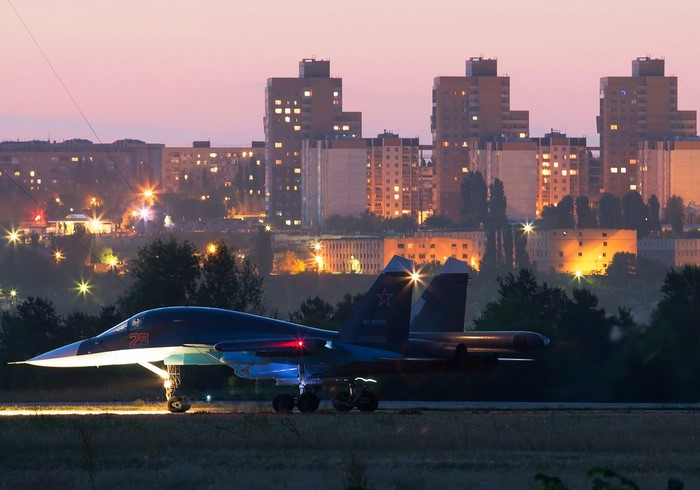 Sukhoi Su-34 fighter jet on runway at dusk