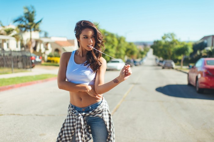 Woman chewing gum in a suburban street