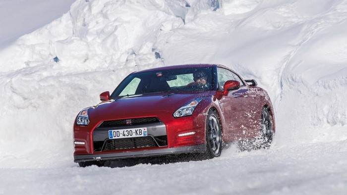 Red Nissan GT-R driving through snow