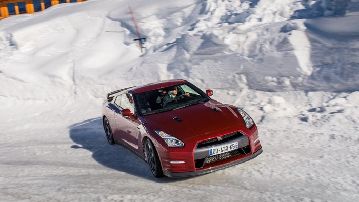 Red Nissan GT-R driving on a snowy road