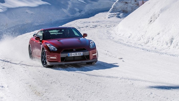 Red Nissan GT-R driving on a snowy road