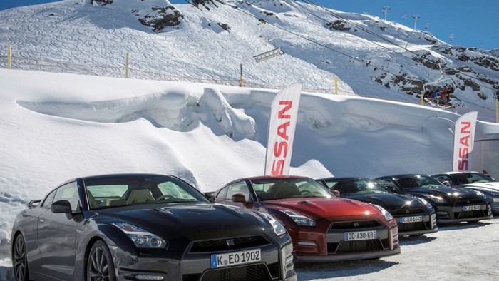 Nissan GT-R cars parked in snow with ski resort background