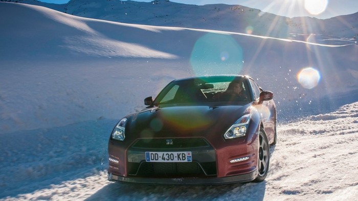 Nissan GT-R driving on a snowy mountain road