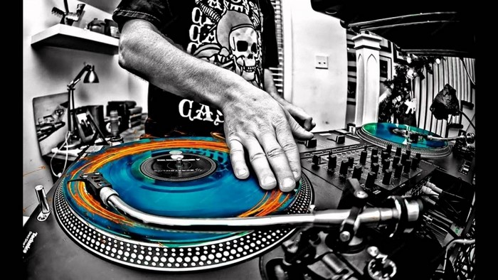 DJ playing turntables with selective coloring
