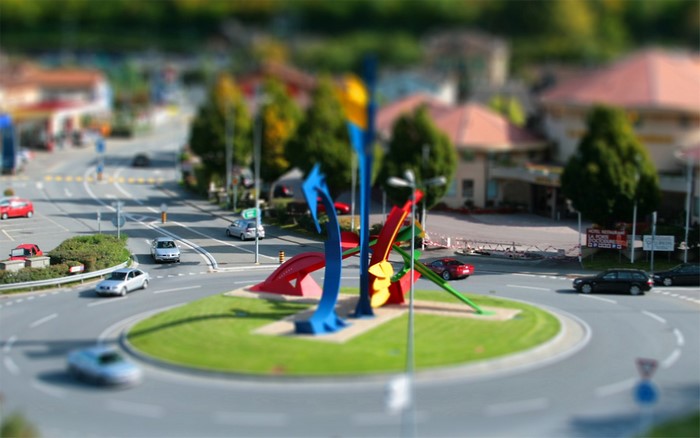 Roundabout with abstract sculpture and cars