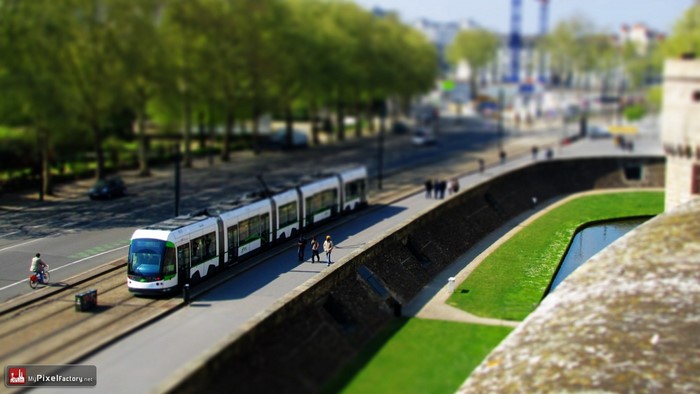 Tram on a street in Nantes with a canal