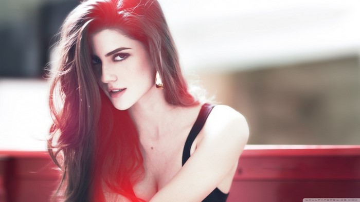 Woman with long brown hair and red lighting