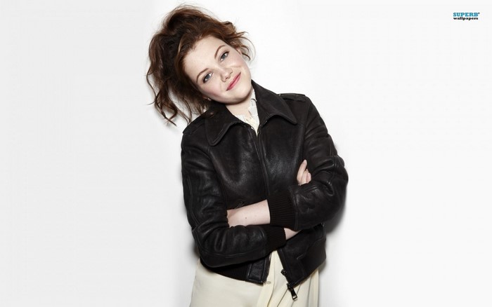 Woman in leather jacket with arms crossed