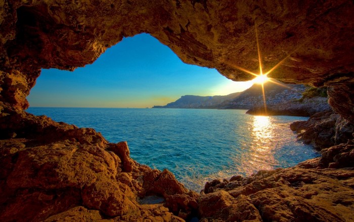 View from a cave of the sea at sunset