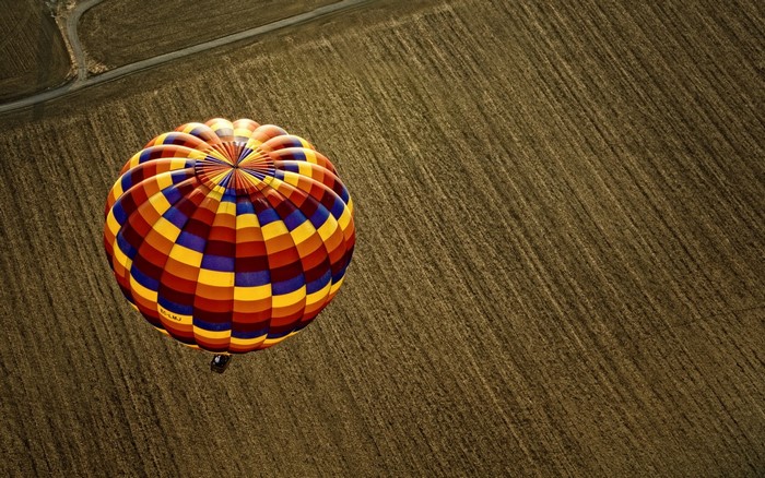Colorful hot air balloon over a field
