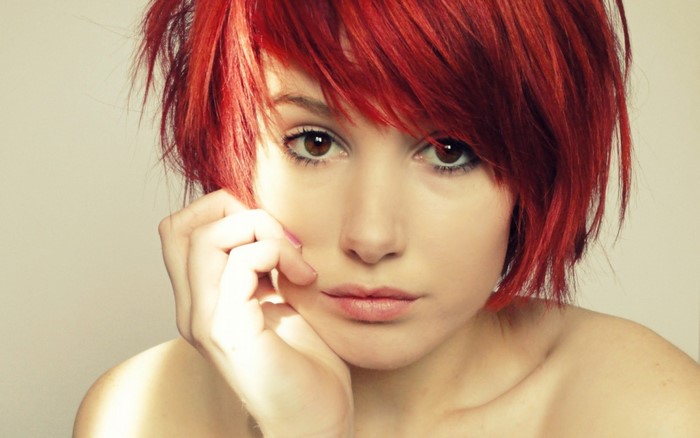 Woman with short red hair and brown eyes