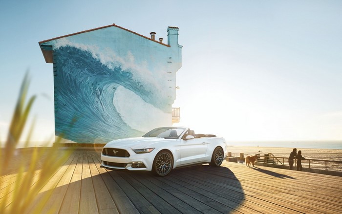 White Ford Mustang Convertible on Boardwalk with Wave Mural