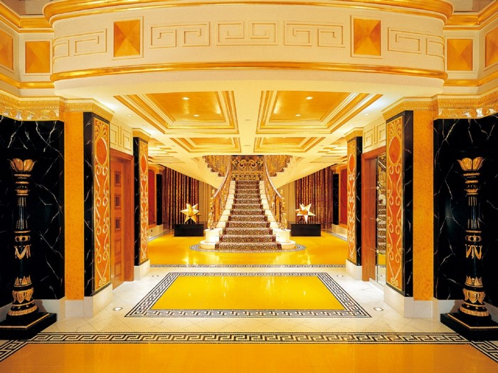 Luxurious gold and marble interior with grand staircase