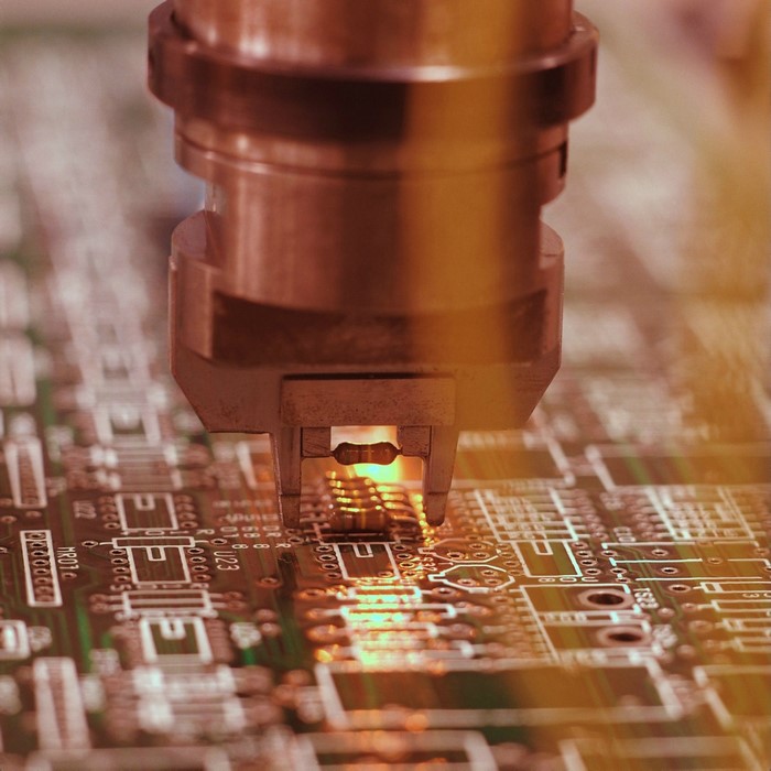 Automated machine placing component on a circuit board