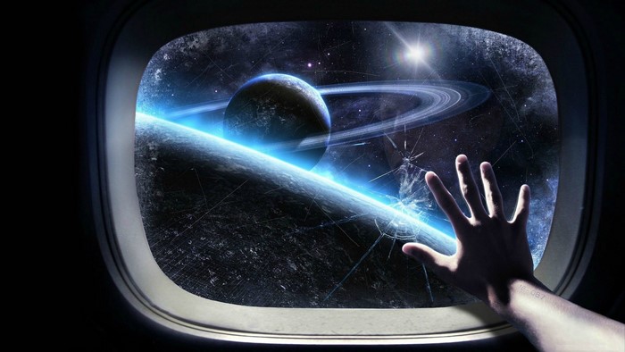 Hand reaching out of airplane window to space