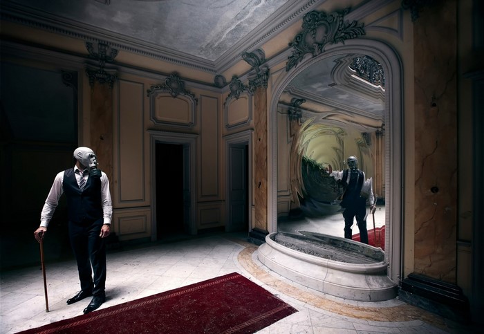 Man in gas mask with cane in ornate room with distorted reflection