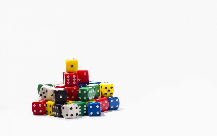Pile of colorful dice on a white background