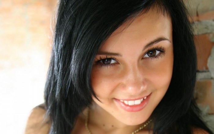 Smiling Woman with Black Hair Close-Up Portrait