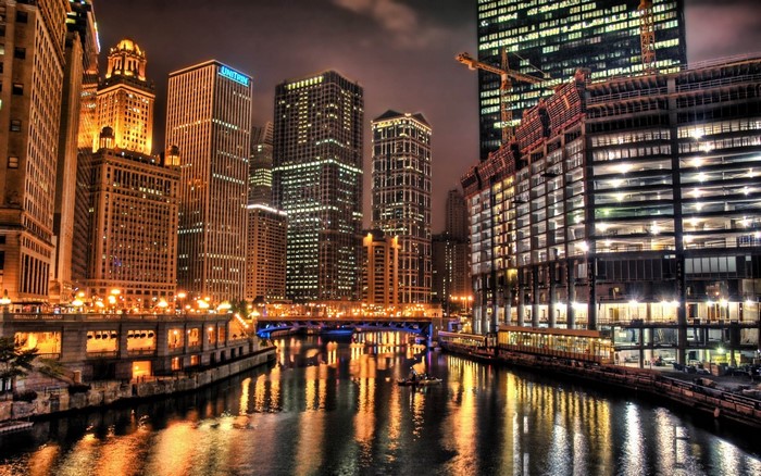 Chicago River at night with skyscrapers and construction