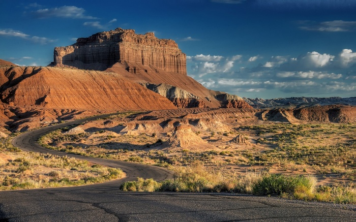 Desert landscape with winding road and rock formations
