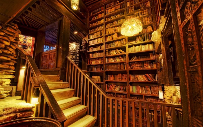 Interior of a library with wooden stairs and bookshelves