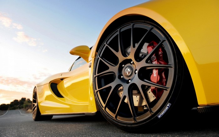 Yellow sports car with black rims and red brake calipers