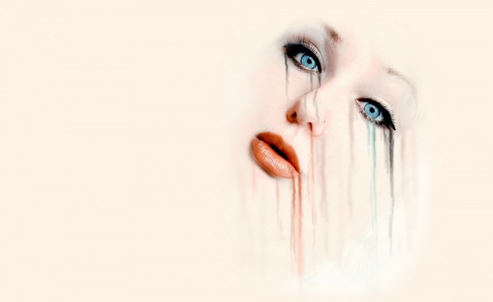 Close up of a woman's face with dripping makeup