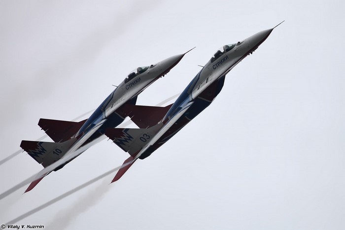 Two MiG-29 fighter jets performing aerobatics