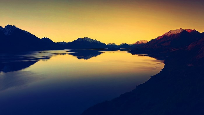 Mountain range reflected in a lake at sunset