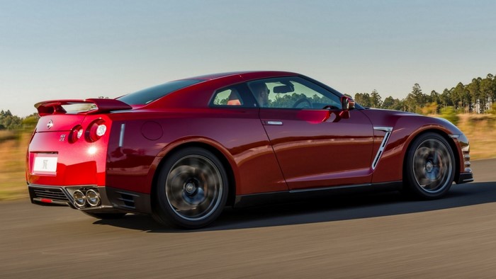 Red Nissan GT-R driving on a road