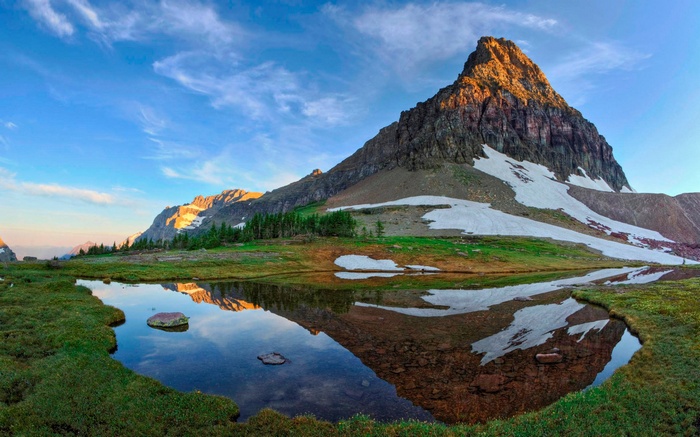 Mountain reflected in a calm lake at sunrise