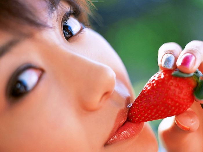 Close-up of Woman Eating a Strawberry