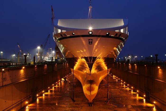 Ship in dry dock at night with lights
