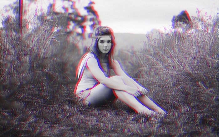 Girl sitting in grass with anaglyph 3D effect