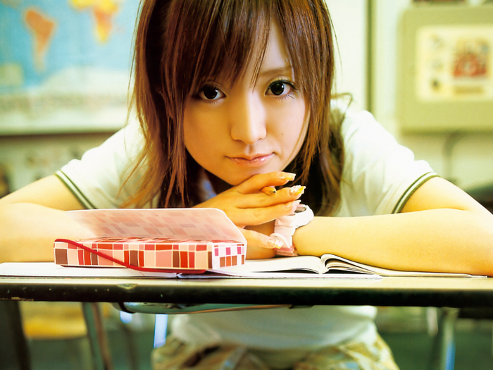 Konno Asami sitting at a desk