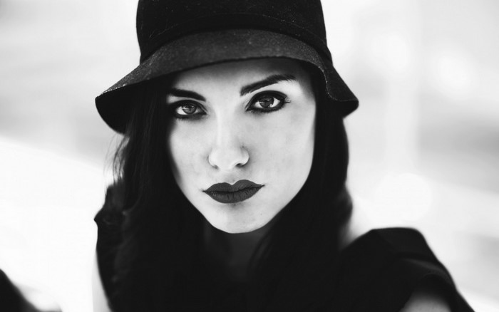 Woman in black hat and dark lipstick