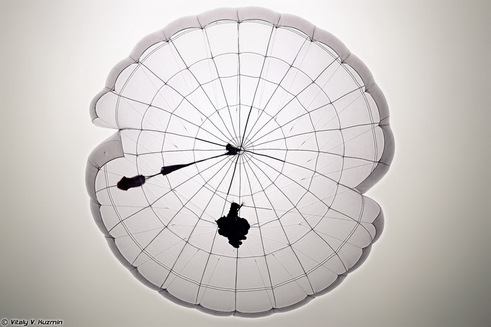 Parachutist silhouetted against a parachute canopy