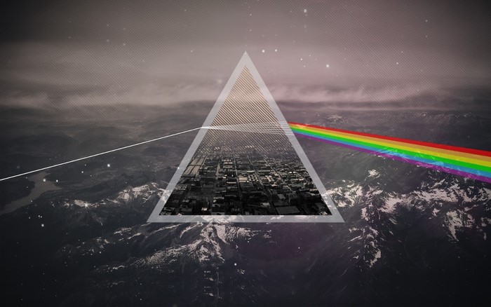 The Dark Side of the Moon prism over city and mountains