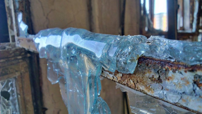 Broken glass on rusty metal