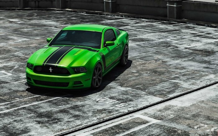 Green Ford Mustang Boss 302 on a concrete surface