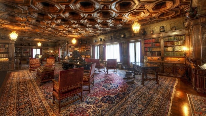 Luxurious library interior with ornate wooden ceiling and antique furniture