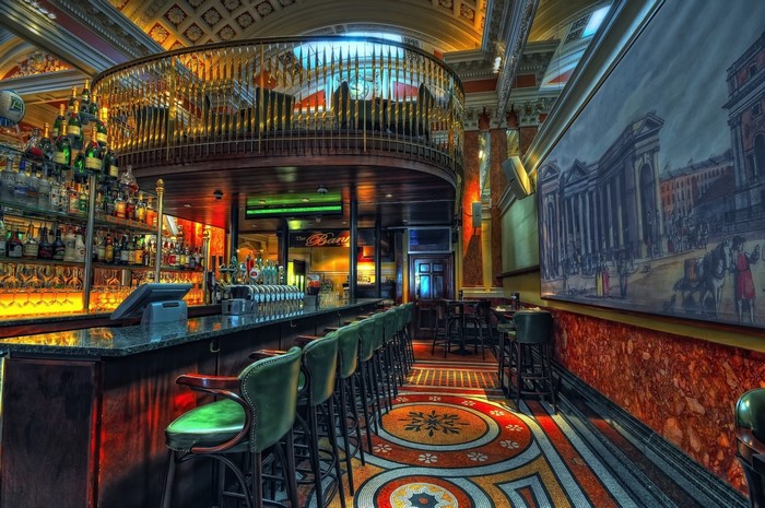 Interior of a bar with a balcony and ornate decor