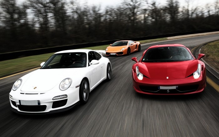 Three sports cars racing on a track