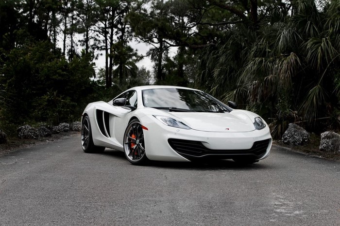 White McLaren MP4-12C parked on a road