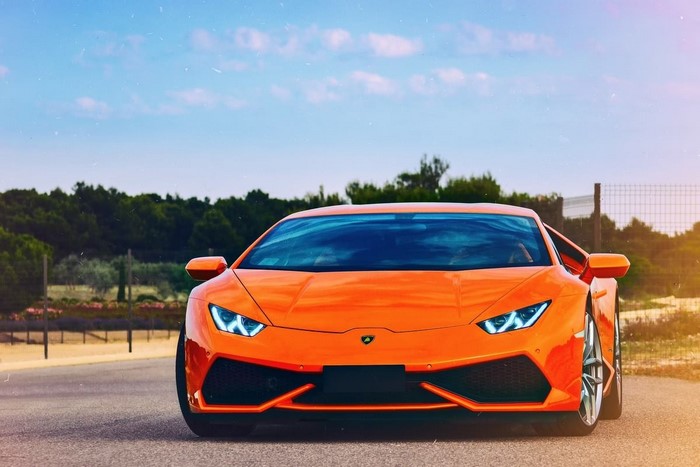 Orange Lamborghini Aventador on a road