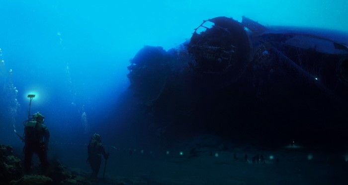 Divers explore a sunken airplane wreck underwater